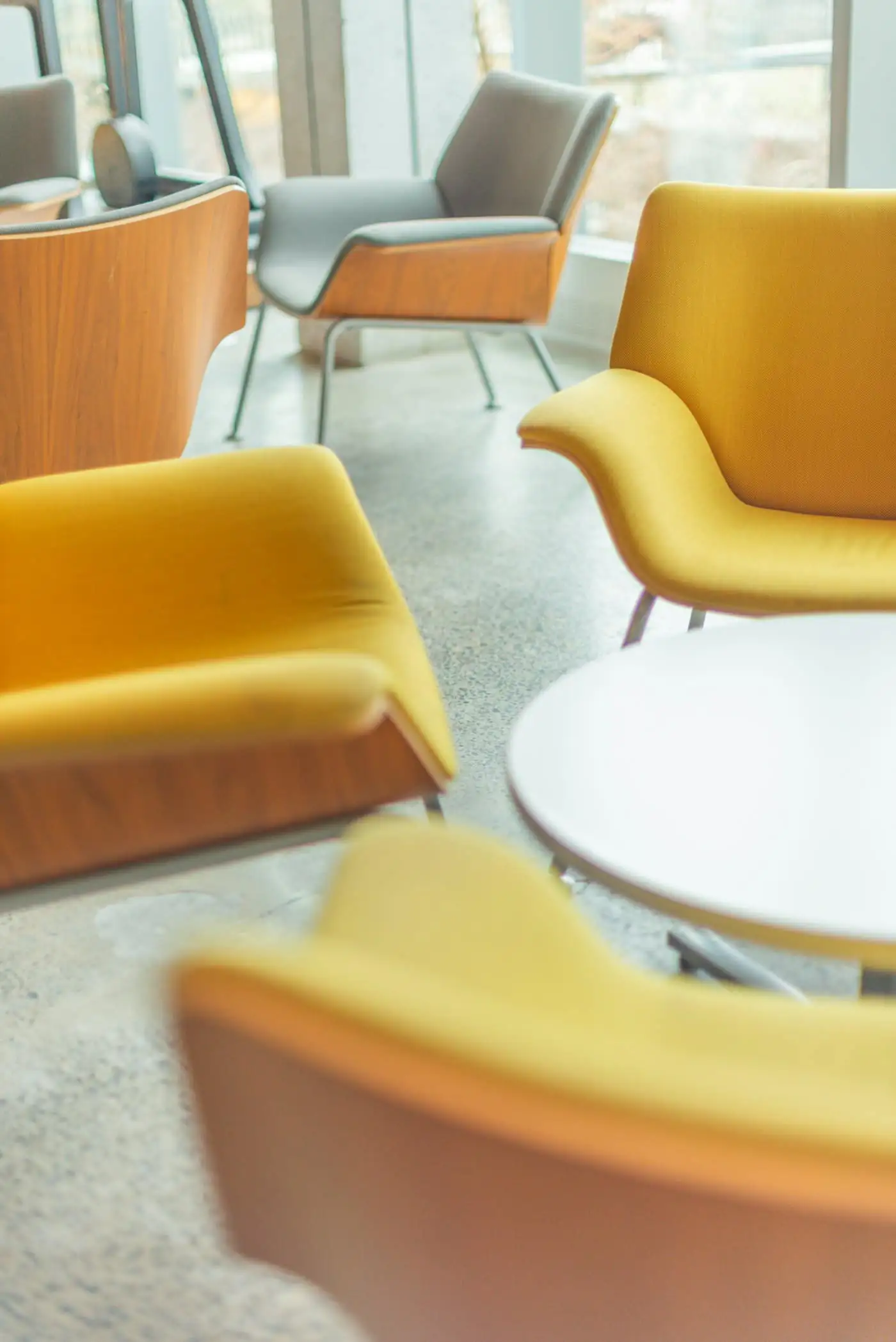 Yellow armchairs and a white table in the parents’ lounge